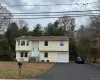 Raised ranch with asphalt driveway and a garage Raised ranch with asphalt driveway and a garage