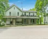 View of front of house with covered porch and a chimney View of front of house with covered porch and a chimney