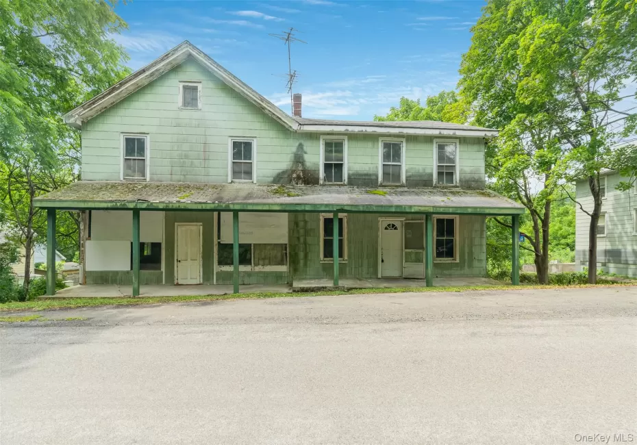 View of front of house with covered porch and a chimney View of front of house with covered porch and a chimney