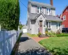 Traditional two-story colonial with gray siding and coordinating roof Traditional two-story colonial with gray siding and coordinating roof