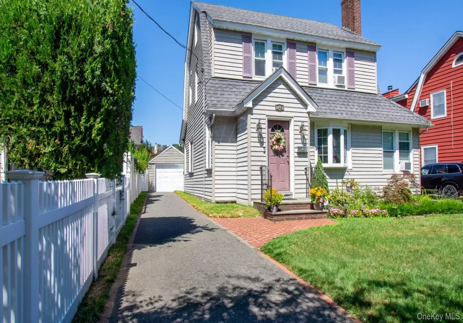 Traditional two-story colonial with gray siding and coordinating roof Traditional two-story colonial with gray siding and coordinating roof