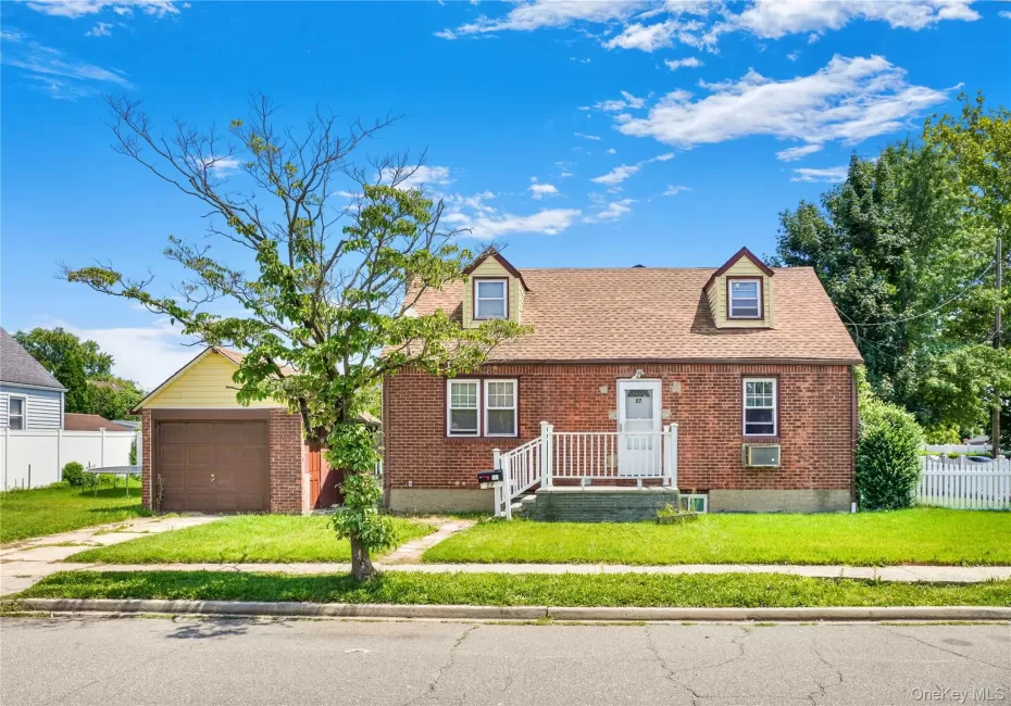 Brick facade home featuring a gabled roof and two dormer windows Brick facade home featuring a gabled roof and two dormer windows