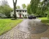 Colonial inspired home featuring asphalt driveway and a front yard Colonial inspired home featuring asphalt driveway and a front yard