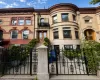 Brick facade with an ornate stone cornice and decorative corbels Brick facade with an ornate stone cornice and decorative corbels