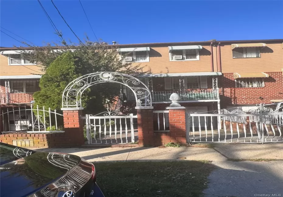 View of front of house featuring a fenced front yard, a gate, and brick siding View of front of house featuring a fenced front yard, a gate, and brick siding