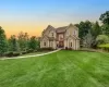 Stucco exterior with stone accents, arched entryway, bay windows, and a paved walkway Stucco exterior with stone accents, arched entryway, bay windows, and a paved walkway