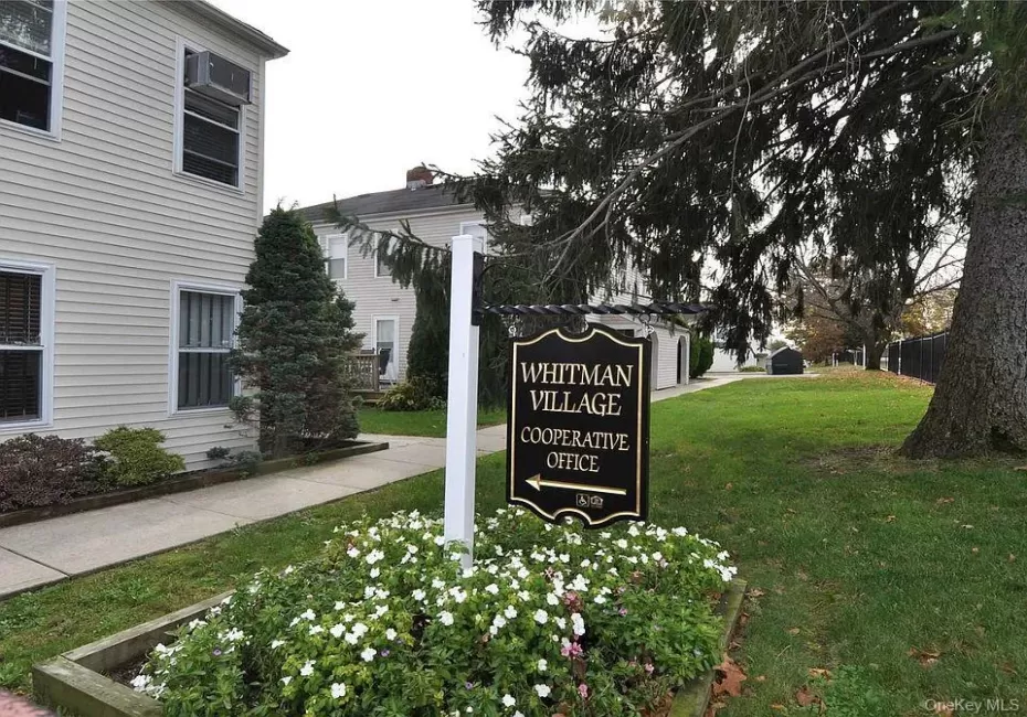 Sign for Whitman Village Cooperative Office near one of the entrances Sign for Whitman Village Cooperative Office near one of the entrances