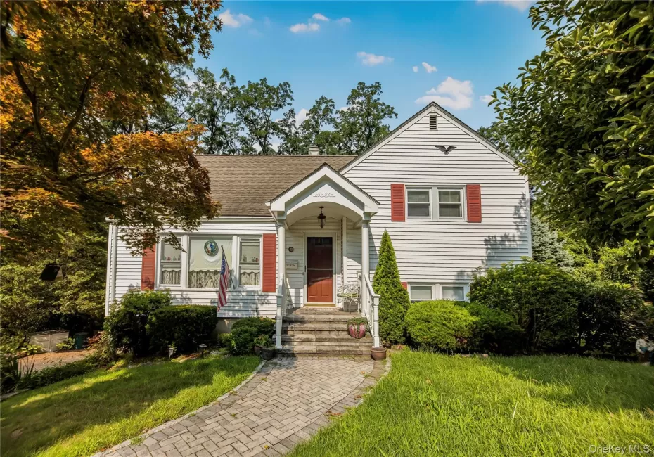 White siding exterior with red window shutters White siding exterior with red window shutters
