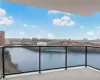 Balcony featuring a skyline view and a water view Balcony featuring a skyline view and a water view