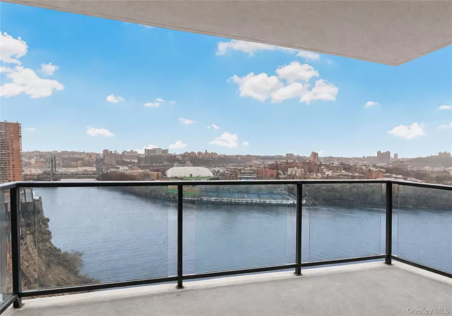 Balcony featuring a skyline view and a water view Balcony featuring a skyline view and a water view