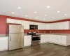 Kitchen featuring stainless steel appliances, recessed lighting, white cabinetry, dark wood-style flooring, and light stone counters Kitchen featuring stainless steel appliances, recessed lighting, white cabinetry, dark wood-style flooring, and light stone counters
