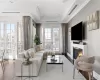 Living area featuring visible vents, ornamental molding, a lit fireplace, hardwood / wood-style flooring, and french doors Living area featuring visible vents, ornamental molding, a lit fireplace, hardwood / wood-style flooring, and french doors