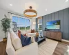 Spacious living area featuring large windows with wood-finish flooring. Spacious living area featuring large windows with wood-finish flooring.