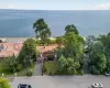 Waterfront property featuring a sandy shoreline and mature trees Waterfront property featuring a sandy shoreline and mature trees