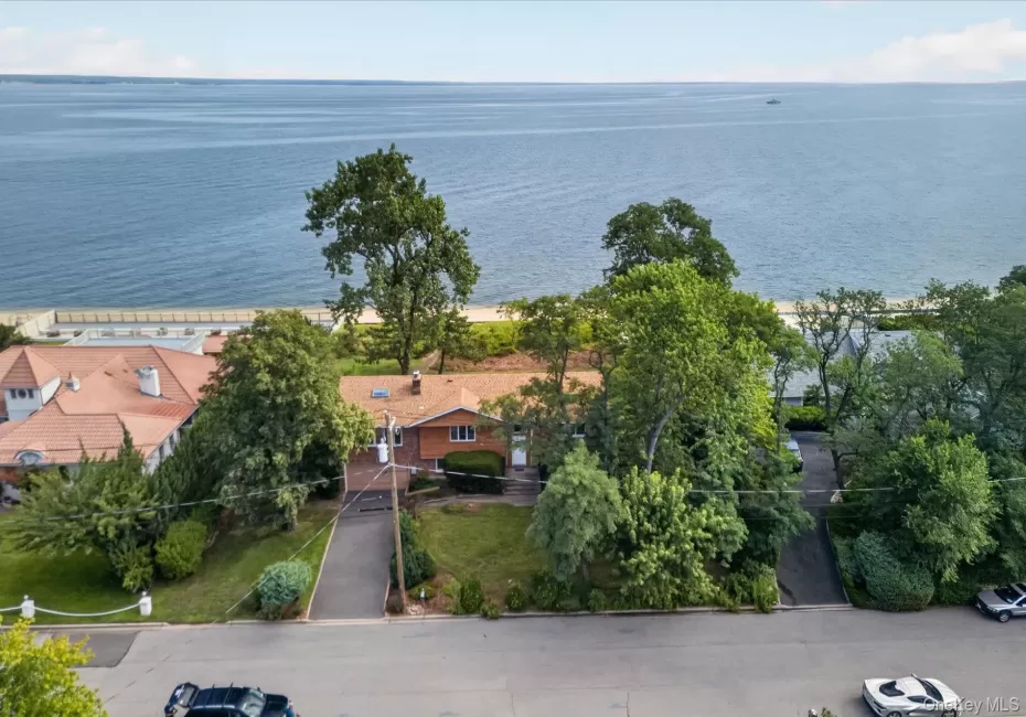 Waterfront property featuring a sandy shoreline and mature trees Waterfront property featuring a sandy shoreline and mature trees