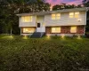 Split-level residence featuring a brick and siding exterior, multiple windows, and exterior steps with handrails Split-level residence featuring a brick and siding exterior, multiple windows, and exterior steps with handrails