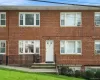 Inviting brick exterior with sun-drenched multi-pane windows and a covered entry stoop Inviting brick exterior with sun-drenched multi-pane windows and a covered entry stoop
