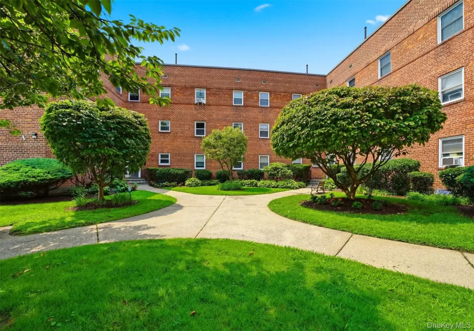 Well-maintained community courtyard with paved walkways and lush landscaping. Well-maintained community courtyard with paved walkways and lush landscaping.