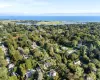 Aerial view of residential area with property boundaries highlighted and a nearby body of water Aerial view of residential area with property boundaries highlighted and a nearby body of water