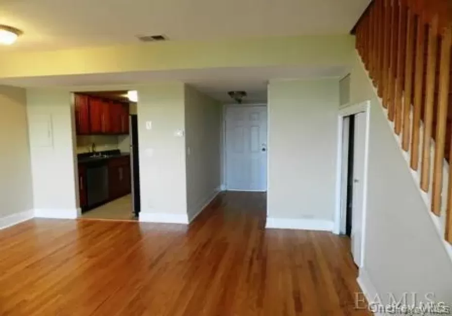 Unfurnished living room featuring hardwood / wood-style floors Unfurnished living room featuring hardwood / wood-style floors