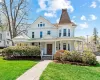 Victorian home featuring a porch and a front lawn Victorian home featuring a porch and a front lawn