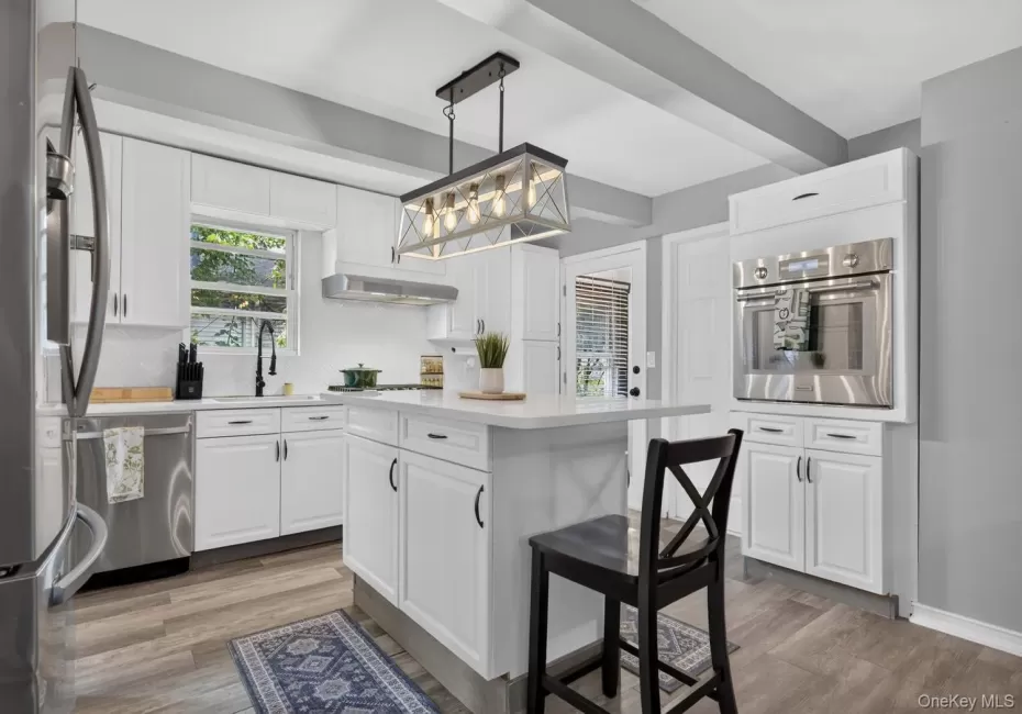 Bright and airy kitchen with white cabinetry and stainless steel appliances Bright and airy kitchen with white cabinetry and stainless steel appliances