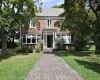 Brick exterior with a gabled roof and bay windows Brick exterior with a gabled roof and bay windows