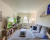 Carpeted living room featuring radiator and a wall mounted air conditioner Carpeted living room featuring radiator and a wall mounted air conditioner