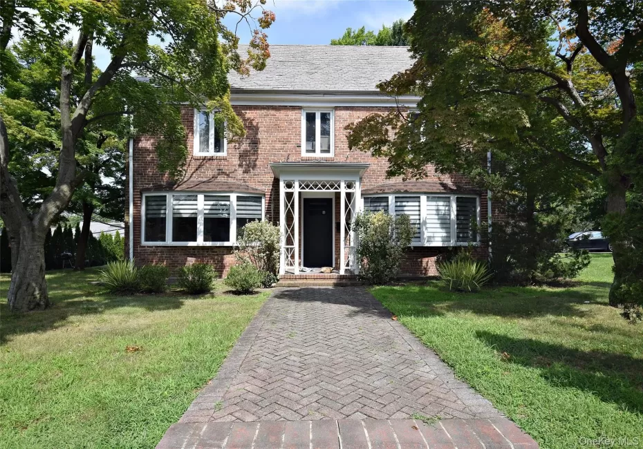 Brick exterior with a gabled roof and bay windows Brick exterior with a gabled roof and bay windows