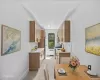 Sleek kitchen featuring wood-finish cabinetry, light-toned countertops, and a stainless steel refrigerator Sleek kitchen featuring wood-finish cabinetry, light-toned countertops, and a stainless steel refrigerator