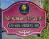 Newport Towers signage featuring a prominent gold tree emblem Newport Towers signage featuring a prominent gold tree emblem