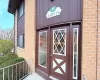 Brick facade with stone accents and dark brown siding Brick facade with stone accents and dark brown siding