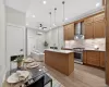 Spacious kitchen featuring wood cabinetry, stainless steel appliances, and a central island with white countertops Spacious kitchen featuring wood cabinetry, stainless steel appliances, and a central island with white countertops