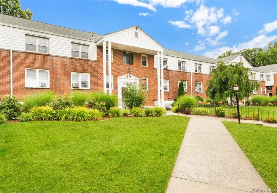 View of front of complex. Brick siding & beautiful green lawn View of front of complex. Brick siding & beautiful green lawn