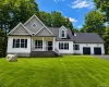 Stunning front exterior showcasing timeless architectural details, covered front porch, oversized two-car garage, mature trees, and expansive lawn. Stunning front exterior showcasing timeless architectural details, covered front porch, oversized two-car garage, mature trees, and expansive lawn.