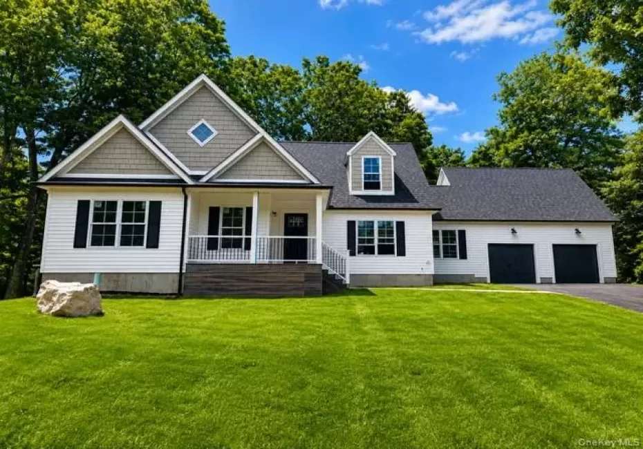 Stunning front exterior showcasing timeless architectural details, covered front porch, oversized two-car garage, mature trees, and expansive lawn. Stunning front exterior showcasing timeless architectural details, covered front porch, oversized two-car garage, mature trees, and expansive lawn.