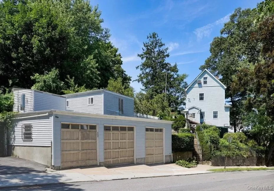 View from the side street. 3 car garage, with two rooms above it. Can be an office or additional storage space. View from the side street. 3 car garage, with two rooms above it. Can be an office or additional storage space.
