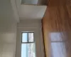 Hardwood flooring, painted walls, window with metal frame, window with city backdrop, baseboard heating Hardwood flooring, painted walls, window with metal frame, window with city backdrop, baseboard heating
