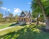 View of front of house featuring covered porch, a chimney, a front yard, and roof with shingles View of front of house featuring covered porch, a chimney, a front yard, and roof with shingles