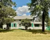 Front view of house with roof with shingles and a lawn Front view of house with roof with shingles and a lawn