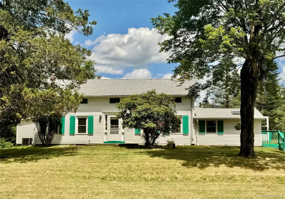 Front view of house with roof with shingles and a lawn Front view of house with roof with shingles and a lawn