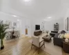 Virtually staged open floor plan featuring proposed living and dining area with wood-type flooring Virtually staged open floor plan featuring proposed living and dining area with wood-type flooring