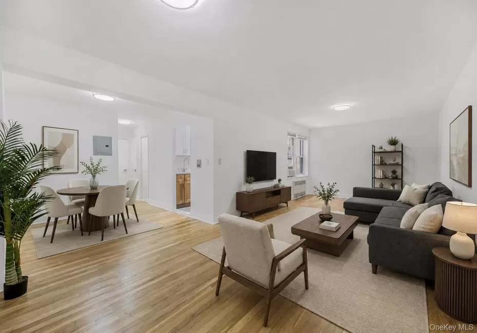 Virtually staged open floor plan featuring proposed living and dining area with wood-type flooring Virtually staged open floor plan featuring proposed living and dining area with wood-type flooring