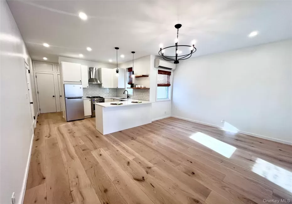 Light wood-finish flooring throughout, complemented by recessed ceiling lighting Light wood-finish flooring throughout, complemented by recessed ceiling lighting