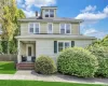Two-story residence featuring dormer windows, a covered front porch with brick stairs, and horizontal and shingle siding Two-story residence featuring dormer windows, a covered front porch with brick stairs, and horizontal and shingle siding