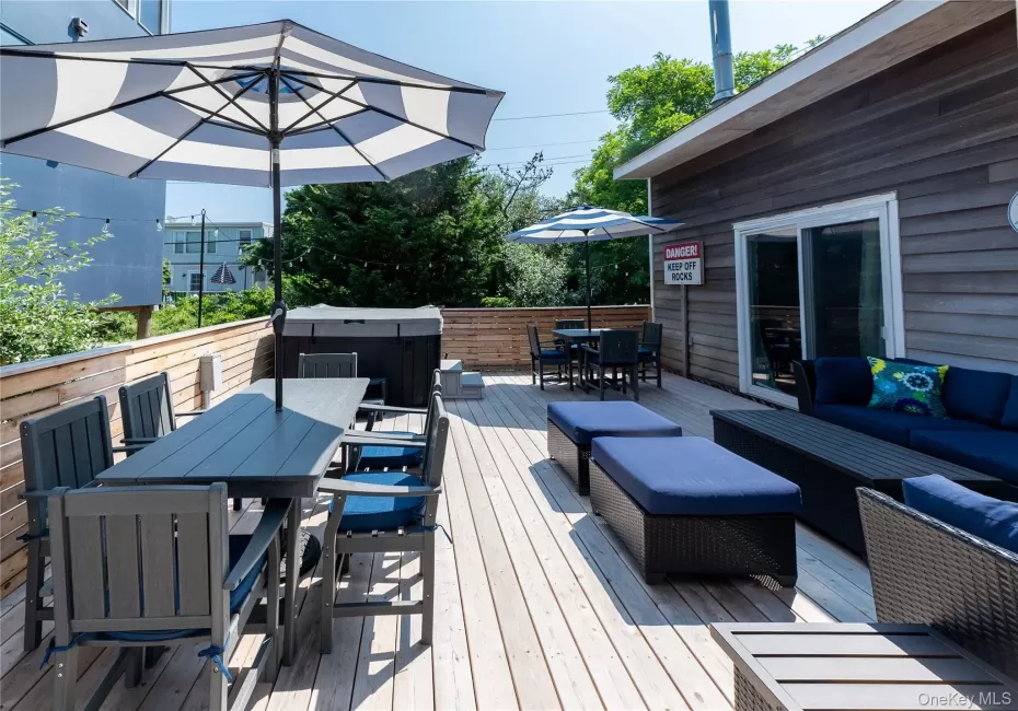 Deck with outdoor dining area, a hot tub, and an outdoor living space Deck with outdoor dining area, a hot tub, and an outdoor living space