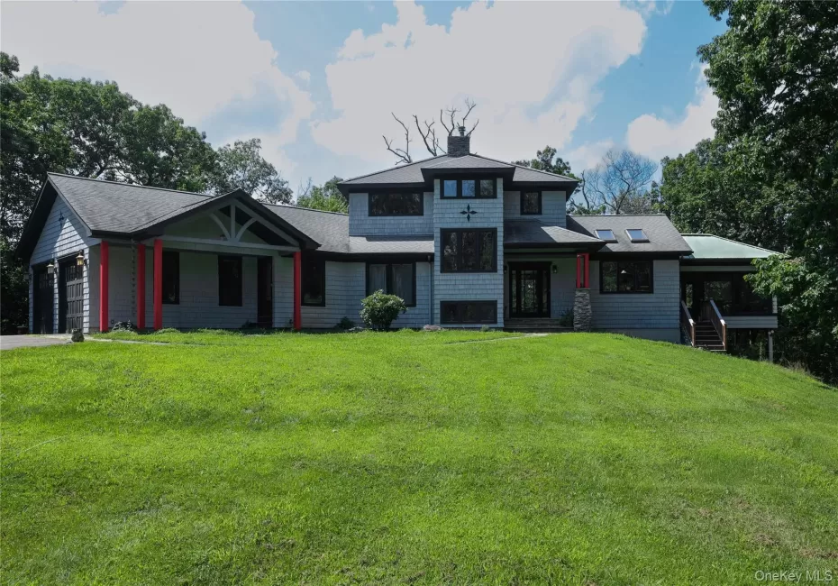 Contemporary architectural style with shingle siding and a multi-level roofline Contemporary architectural style with shingle siding and a multi-level roofline