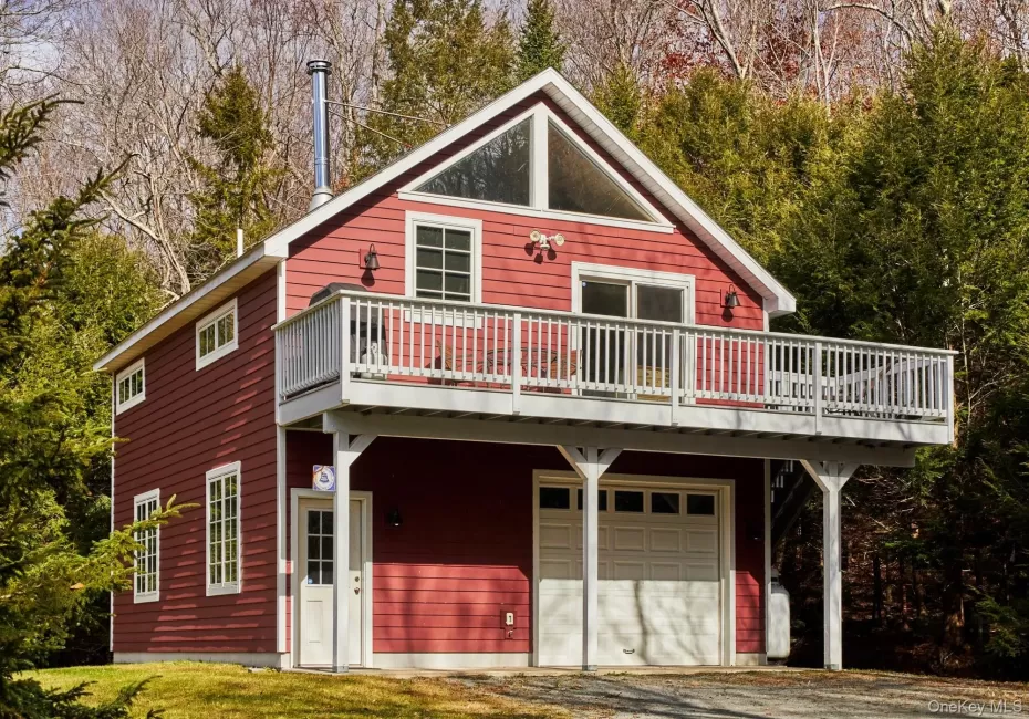 View of front facade featuring a garage, driveway, and view. View of front facade featuring a garage, driveway, and view.
