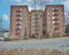 Brick multi-story building featuring multiple windows and exterior fire escapes Brick multi-story building featuring multiple windows and exterior fire escapes