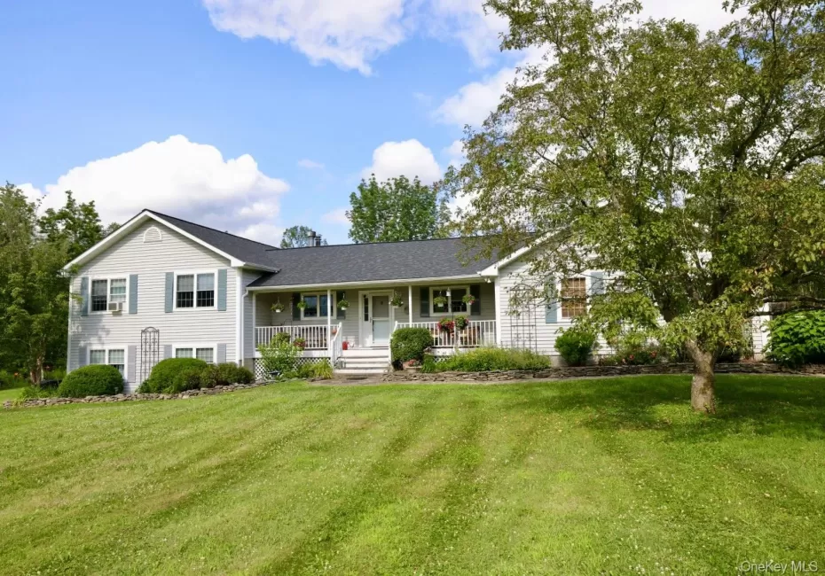 Home with a porch and a front yard Home with a porch and a front yard